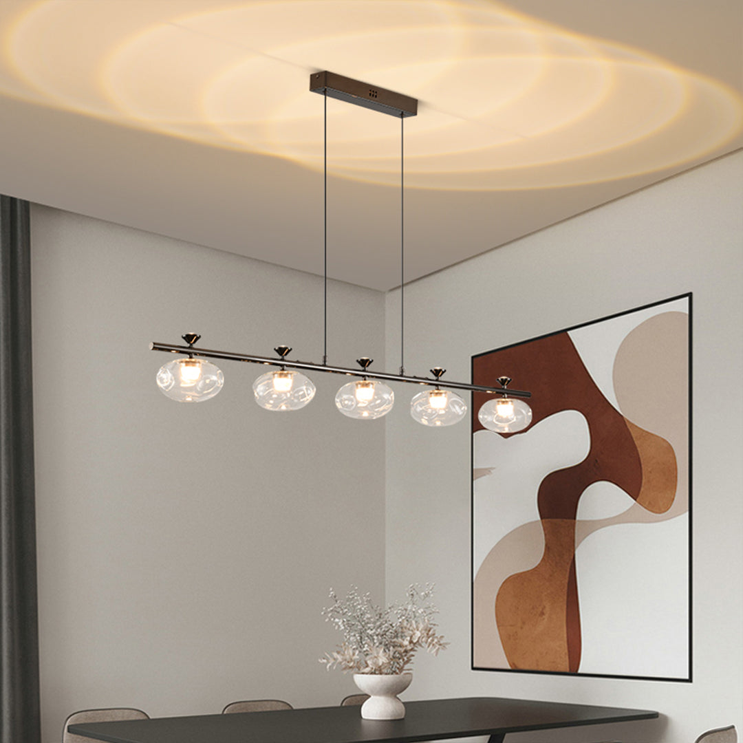 Stylish linear glass chandelier with black metal framework over modern dining space