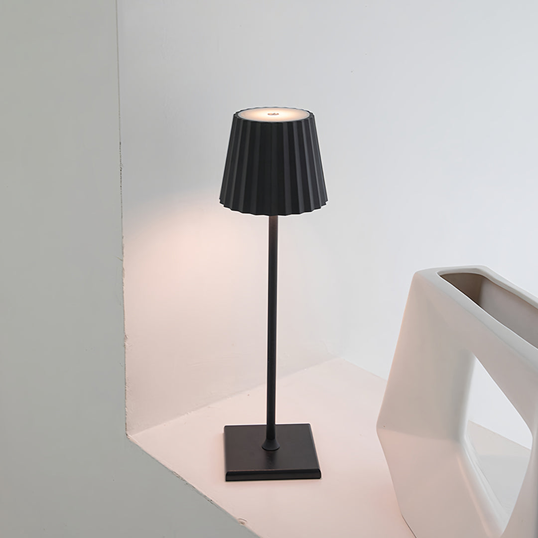 Stylish modern metal table lamp with black finish creating ambient lighting in contemporary setting