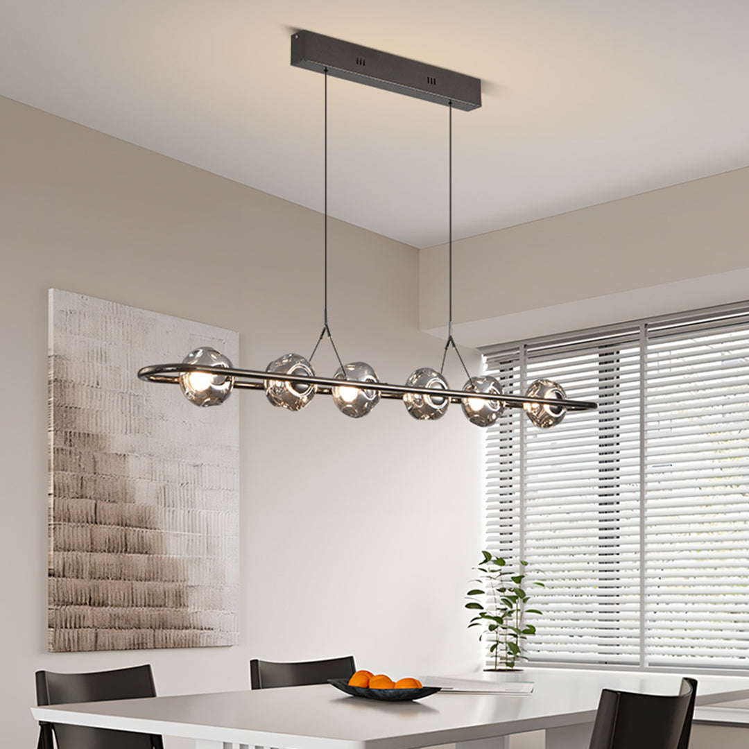 Stylish rise and fall pendant light with black linear track over modern kitchen workspace