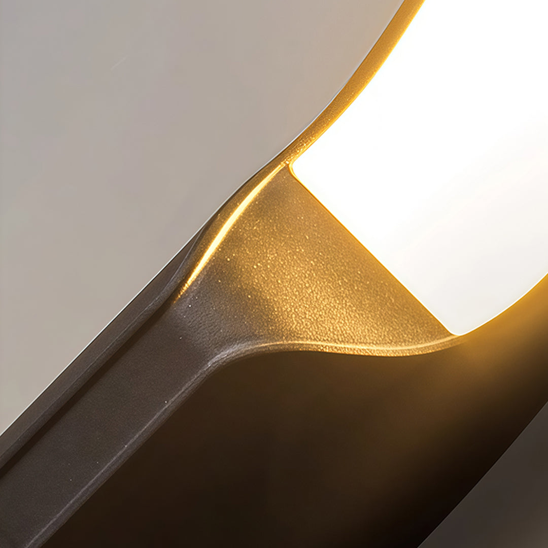 Stylish black outdoor wall light providing energy-efficient lighting for a residential porch area.