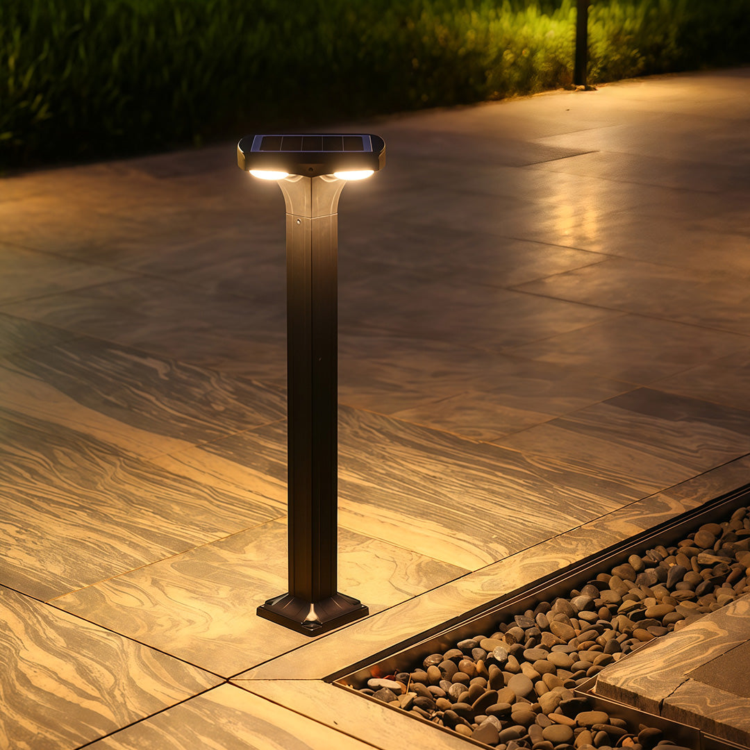 Stylish black wall sconce with a modern design, placed in the garden for illumination.