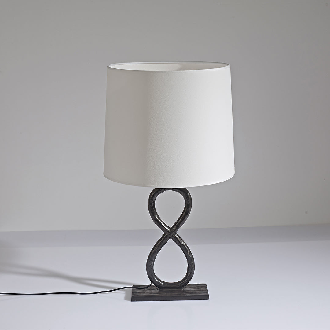 Stylish bronze metal table lamps with twisted metal base and beige shade, minimalist background.