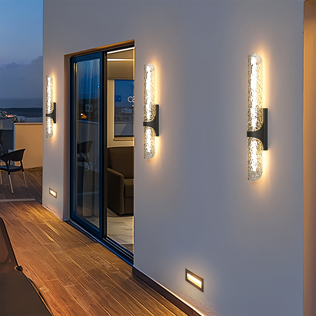 Stylish contemporary black outdoor wall lights with bubble glass illuminating a modern balcony wall.