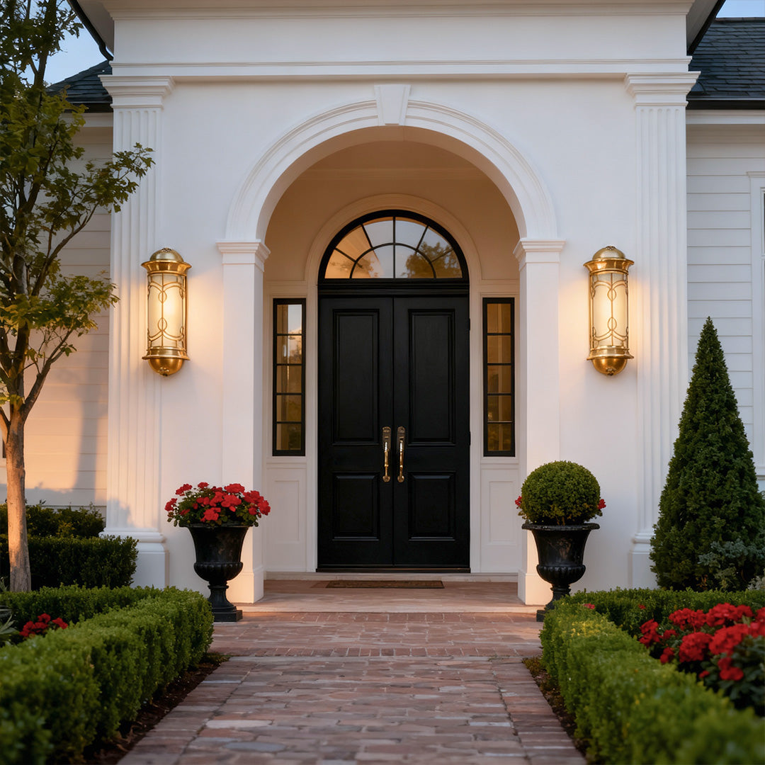 Stylish copper outdoor wall sconce beside a black door, adding a touch of luxury to the home's exterior.