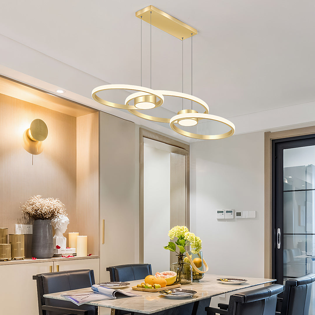 Modern gold chandelier lamp with three rings, chic pendant lighting in a stylish dining room