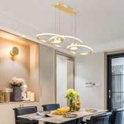 Modern gold chandelier lamp with three rings, chic pendant lighting in a stylish dining room