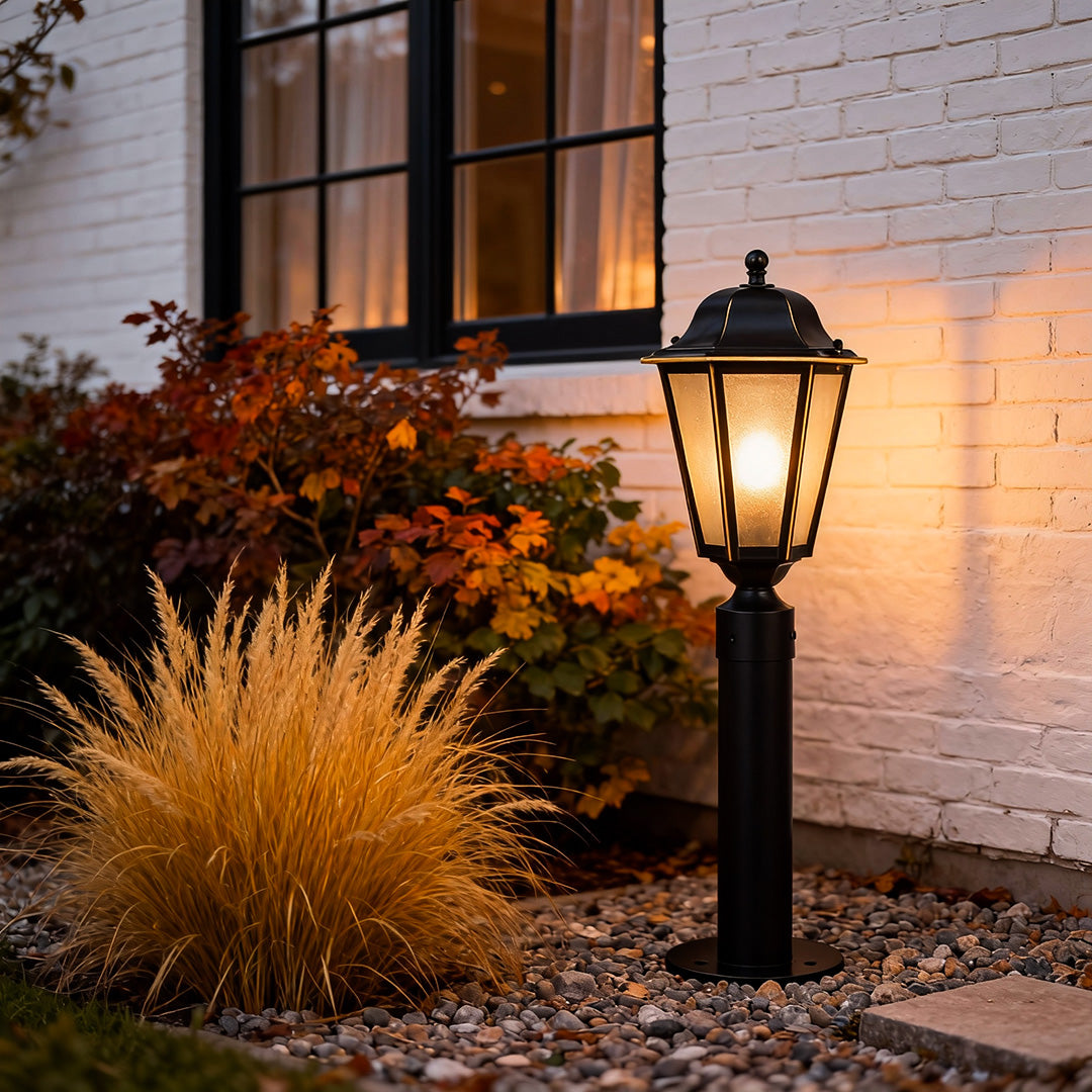 Stylish exterior path lighting beside a gravel pathway, highlighting vibrant plants and evening ambiance.