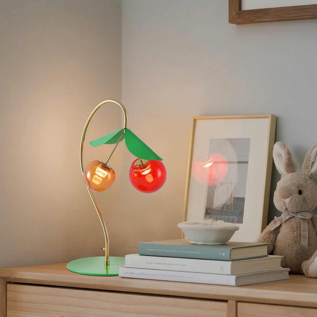 Stylish modern LED table lamps with fruit-inspired glass orbs creating warm desk lighting