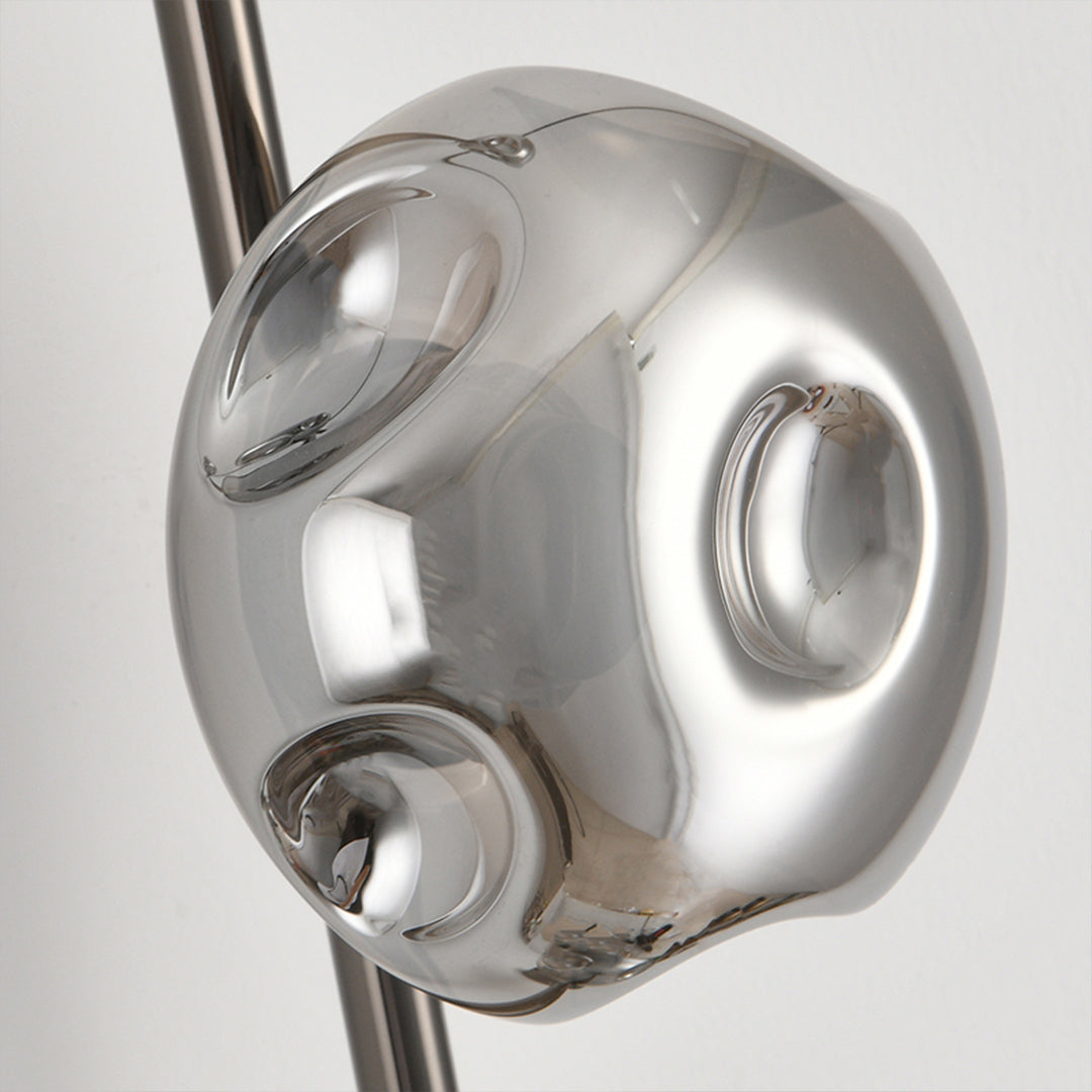 Stylish indoor wall mounted lights positioned beside bed with cascading glass globe design