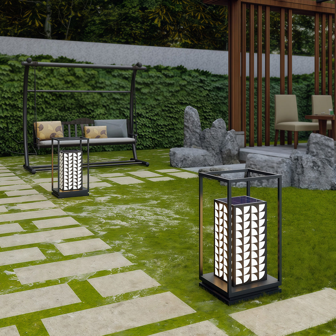 Stylish LED bollard light casting soft light in a landscaped garden, perfect for modern outdoor settings.