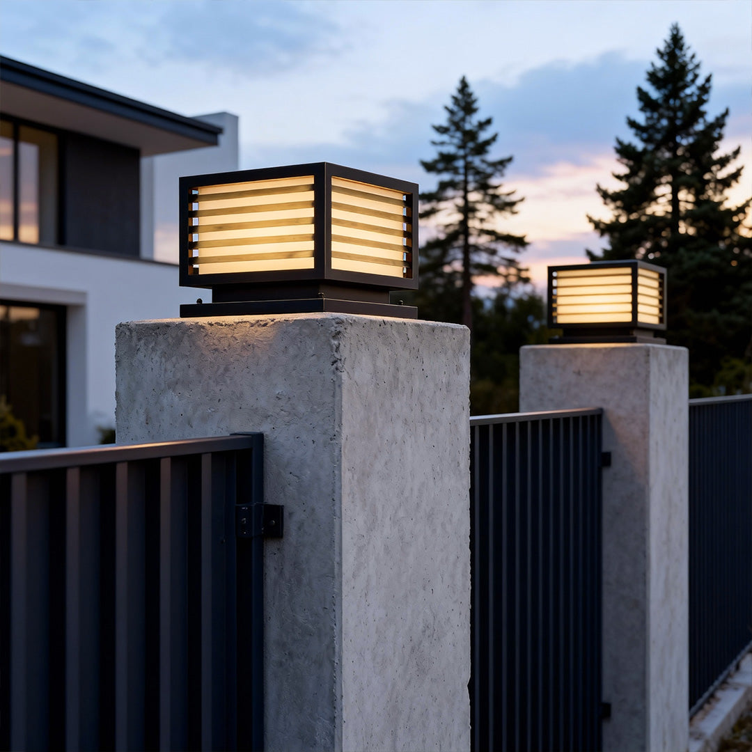 Stylish lights for pillar mounted on a modern fence, adding ambiance to an outdoor pool area.