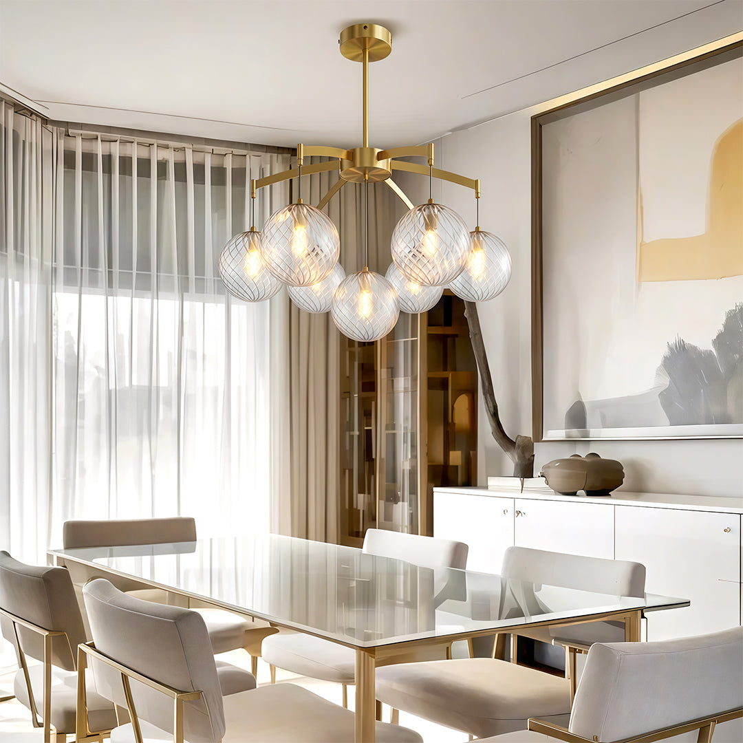 Stylish modern glass ball chandelier with gold accents, illuminating a contemporary living room.