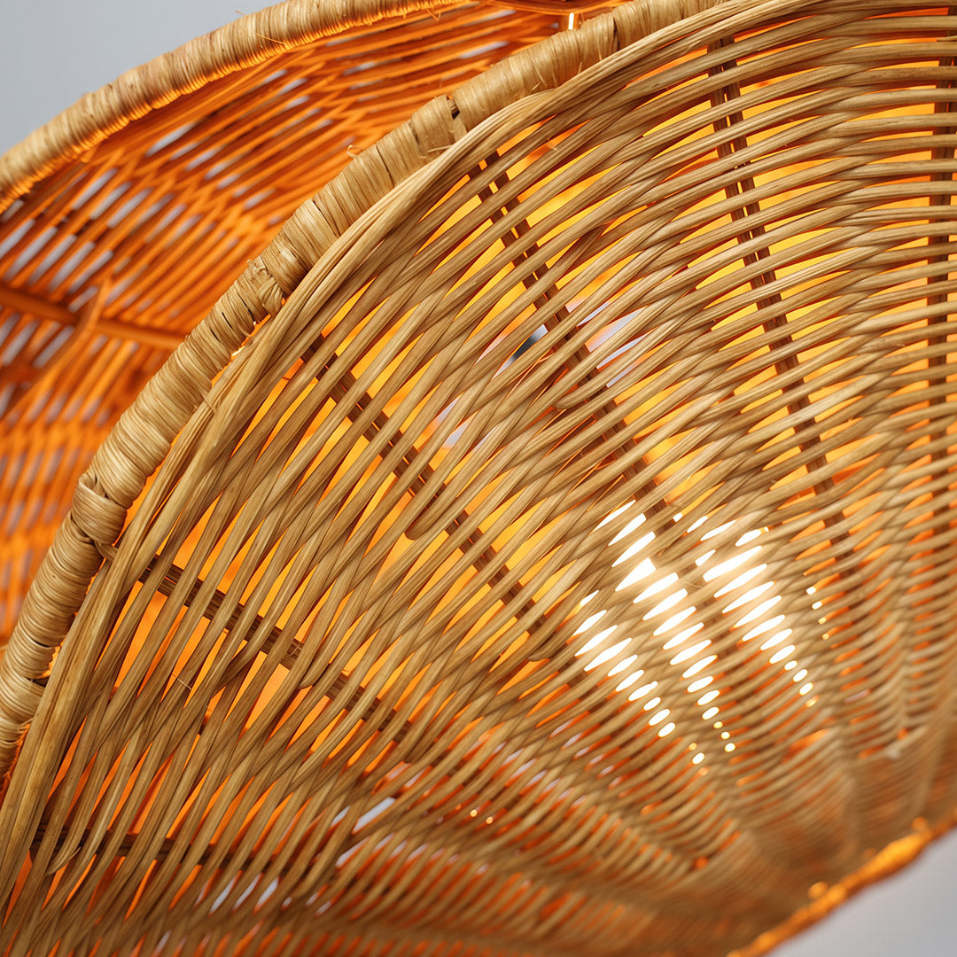 Stylish rattan pendant light hanging in a contemporary dining area, providing soft, ambient lighting.