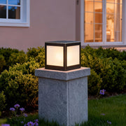 Stylish solar outdoor pillar lights adding elegance to a garden fence with sustainable energy.