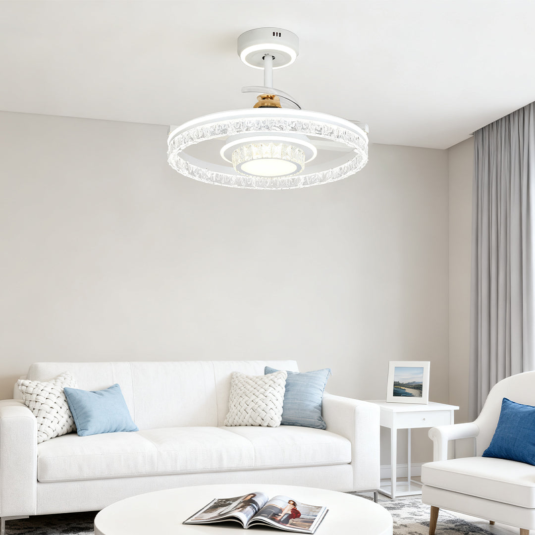 Stylish white ceiling fan with round light centered above a modern white sofa in a minimalist living room with subtle wall art. 