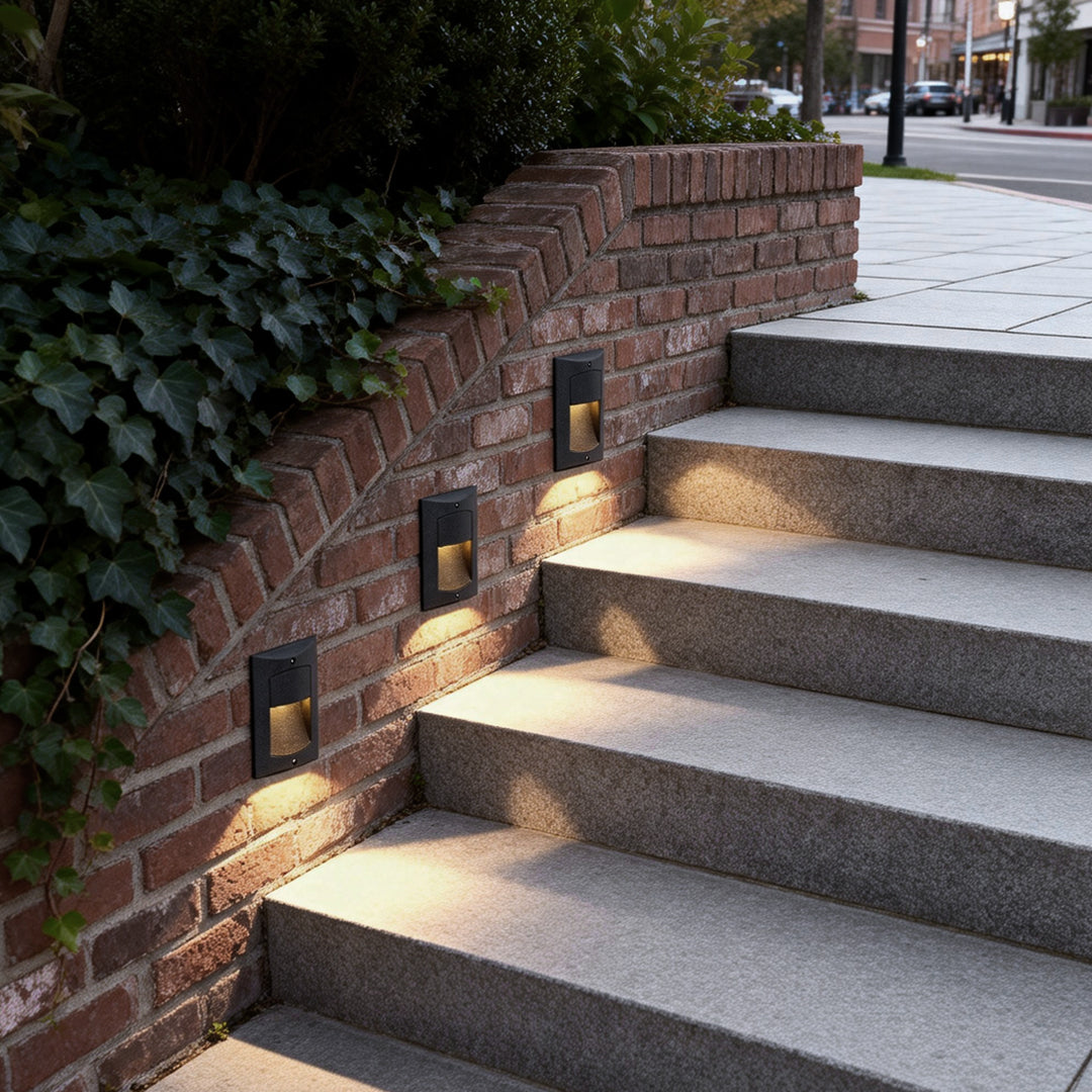 Surface mounted step lights providing soft illumination along a brick stairway.