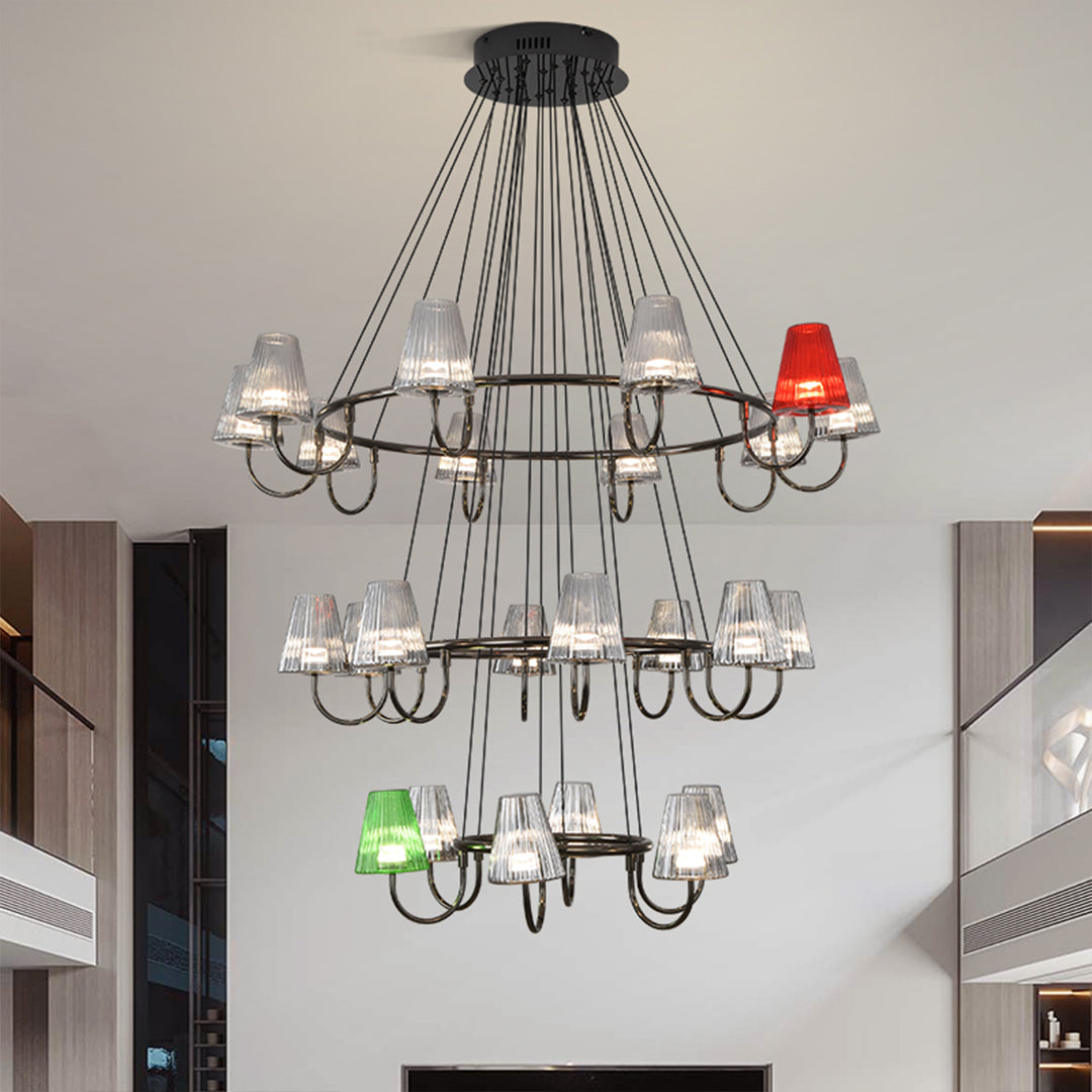 Suspended metal chandelier with fifteenth colorful glass shades in green, red, and clear suspended from ceiling mount