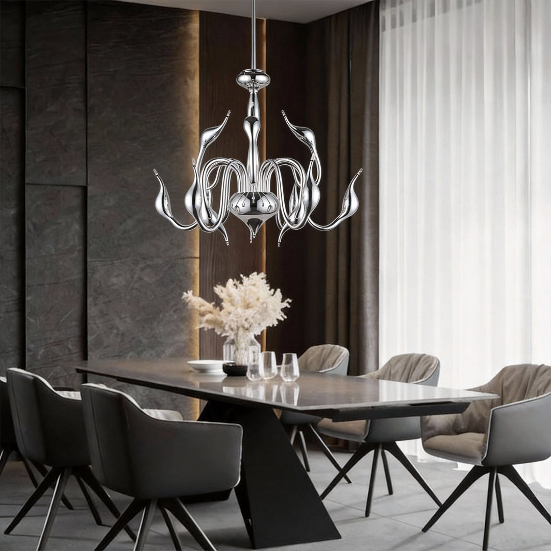 Swan chandelier installed above modern dining table in luxury interior.