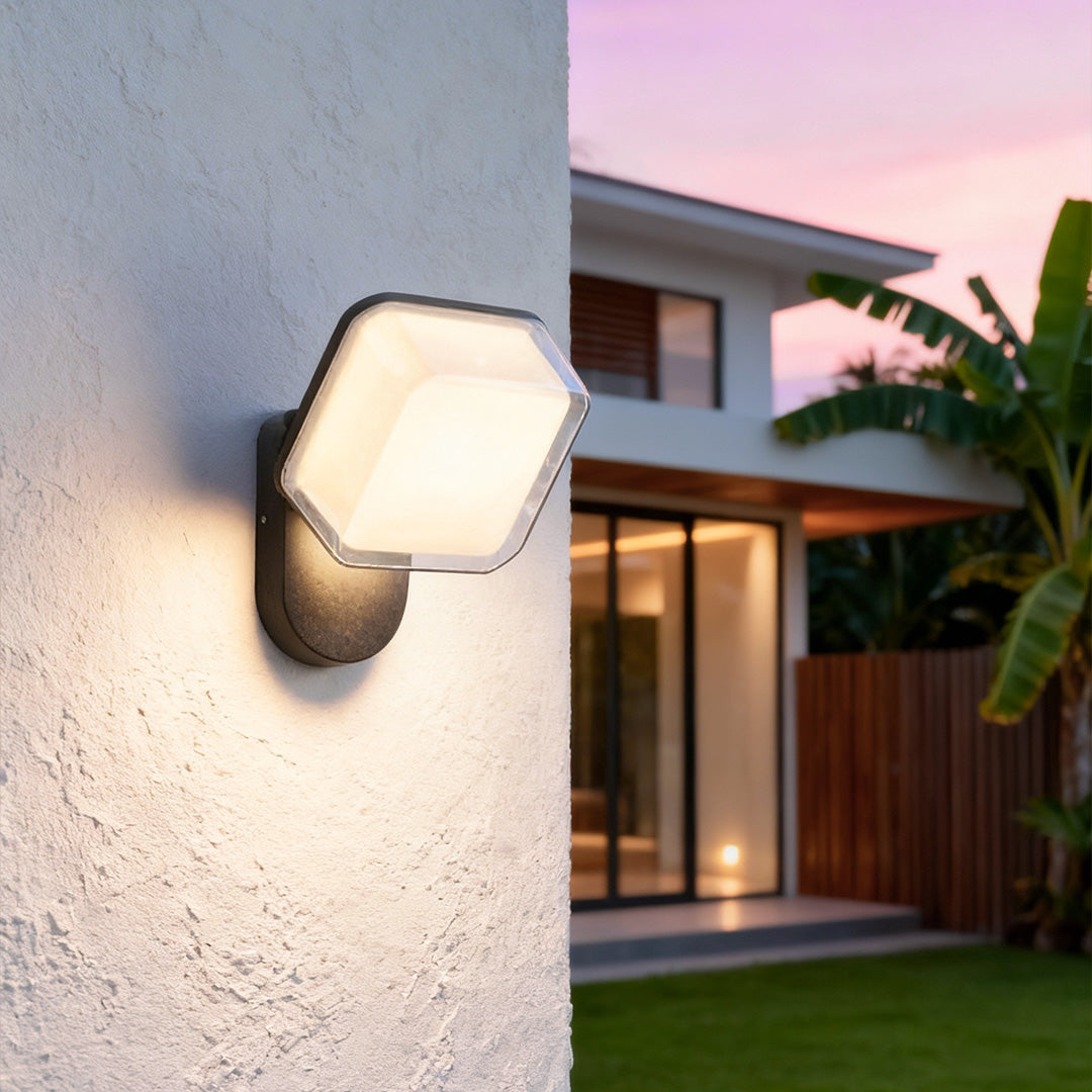 Close-up of textured grey swing wall light with minimalist cubic design for modern architectural lighting.