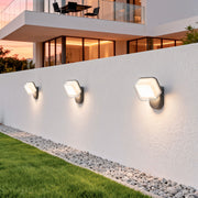 White hexagon swing wall light with bronze accent edge, offering warm decorative wall lighting.