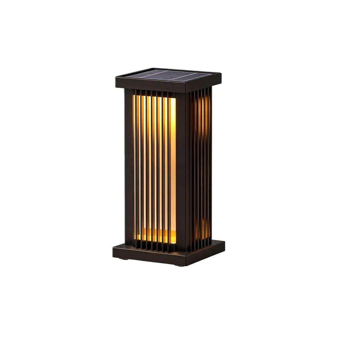 Angled view of a tall black solar outdoor pillar light with warm vertical lighting