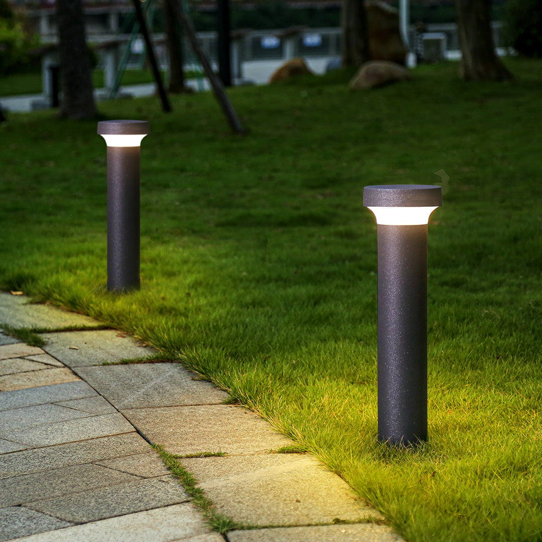 Tall black cylindrical outdoor post light with sleek modern design