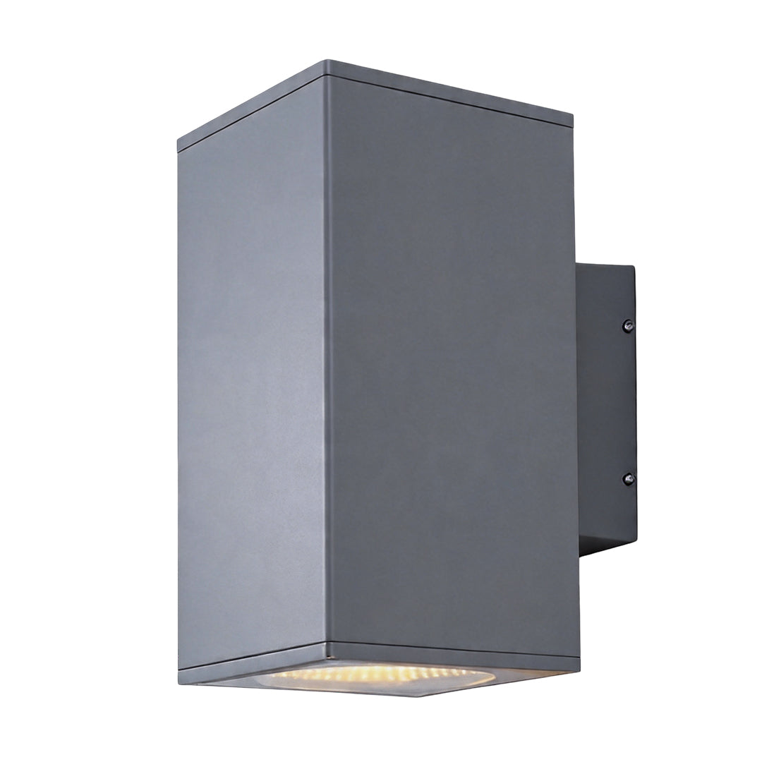 Tall grey wall sconce up and down light fixture with a glowing bulb isolated on white backdrop