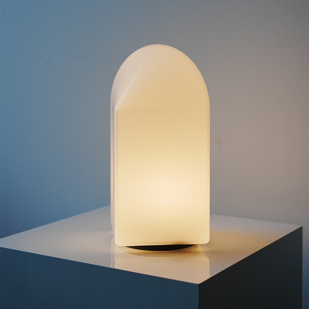 Tall house  modern white table lamp softly illuminating tabletop in modern home.