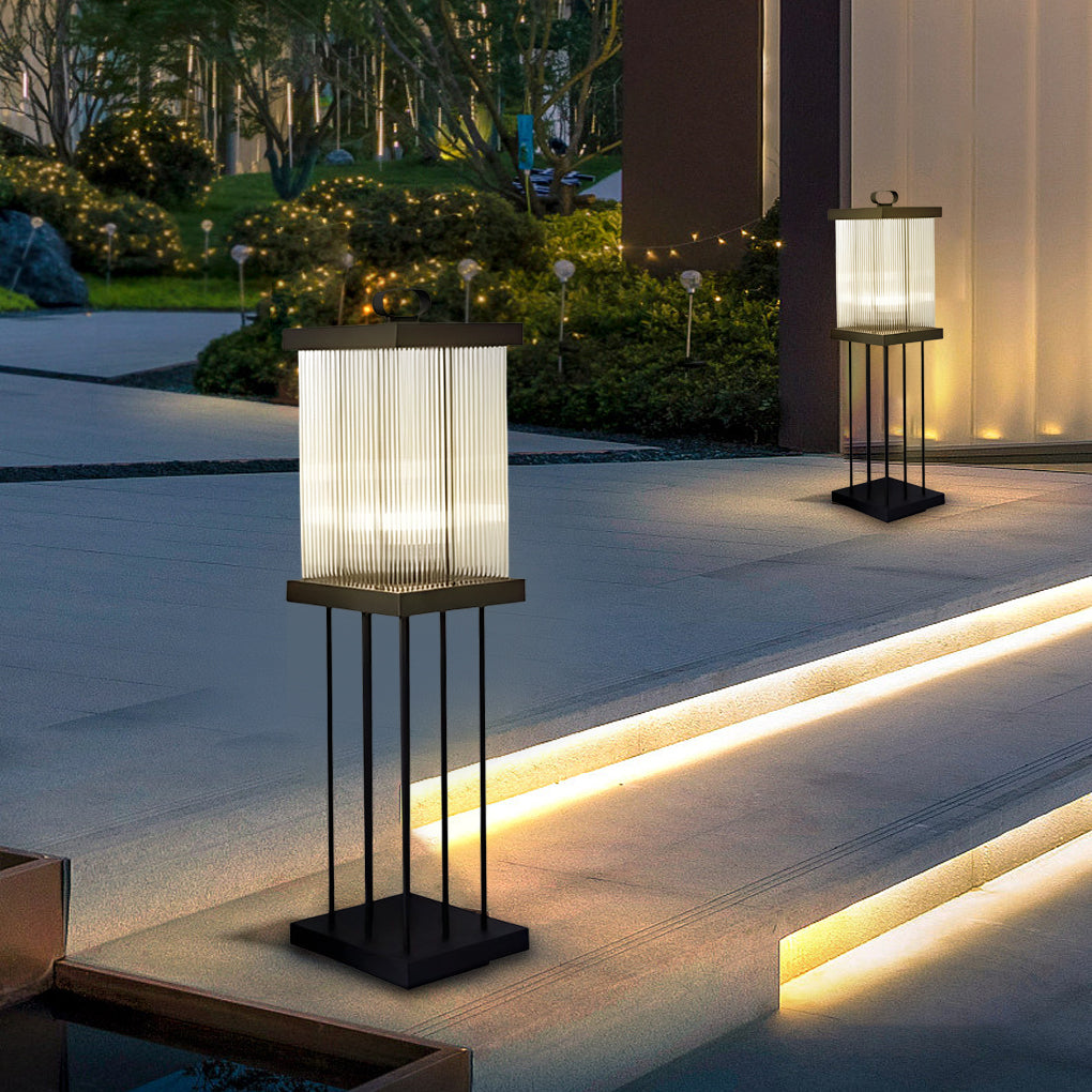 Tall solar lantern on stand enhancing landscape lighting near entrance.