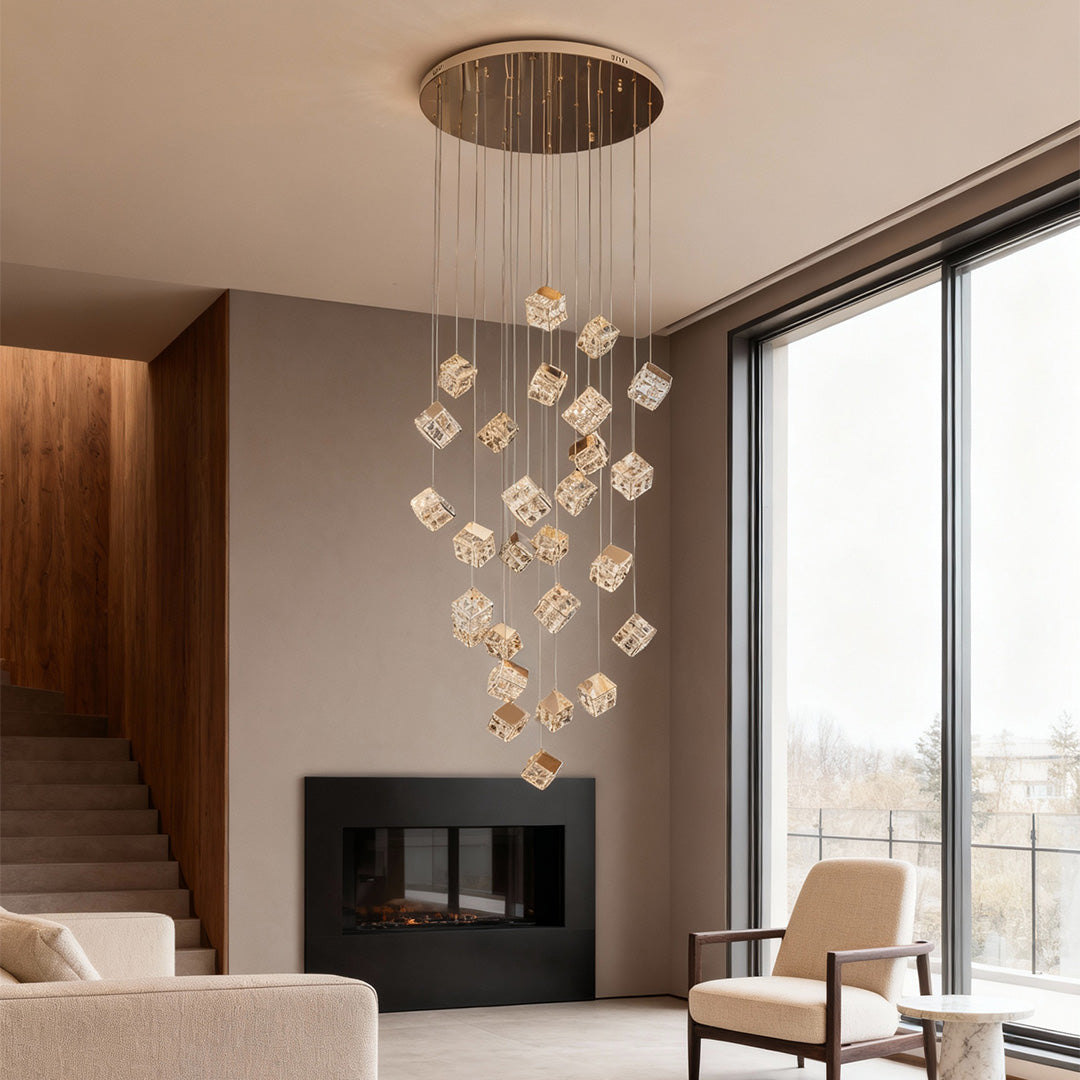 Tall crystal chandelier beside staircase with minimalist interior design.