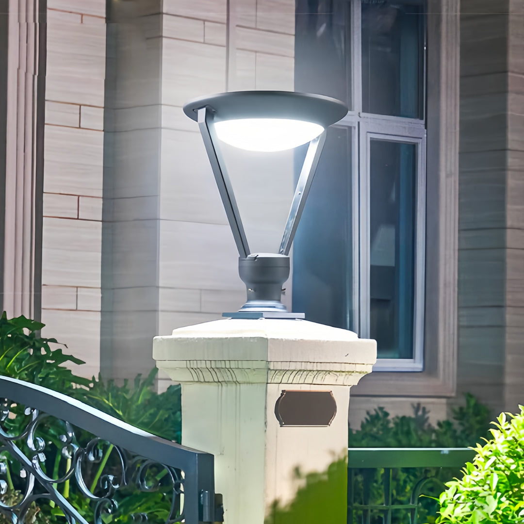 Tall external pillar lights mounted on a large stone gate post, offering focused security and decorative lighting for a home.