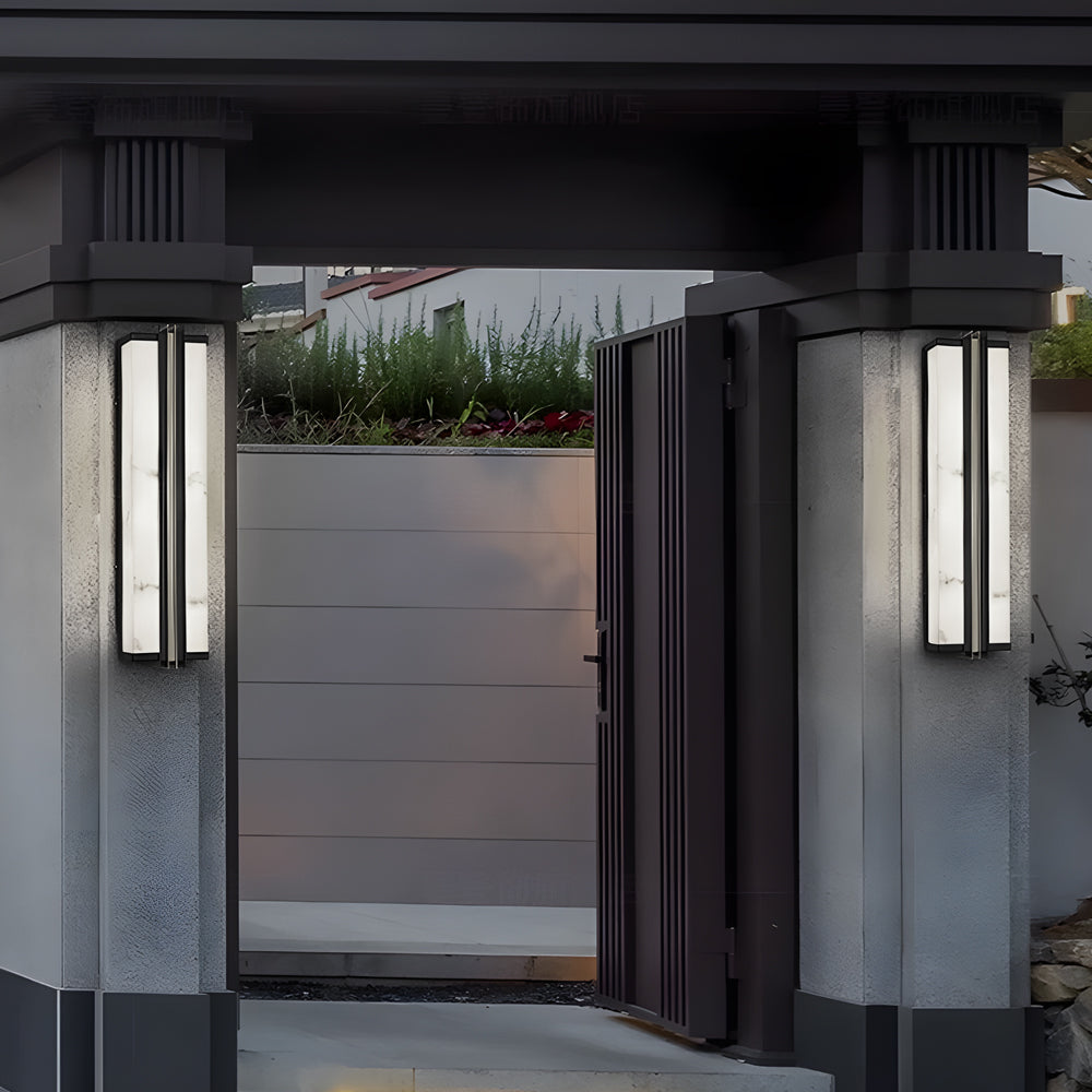 Tall vertical wall light fixture used on exterior gate pillars for modern home lighting design.