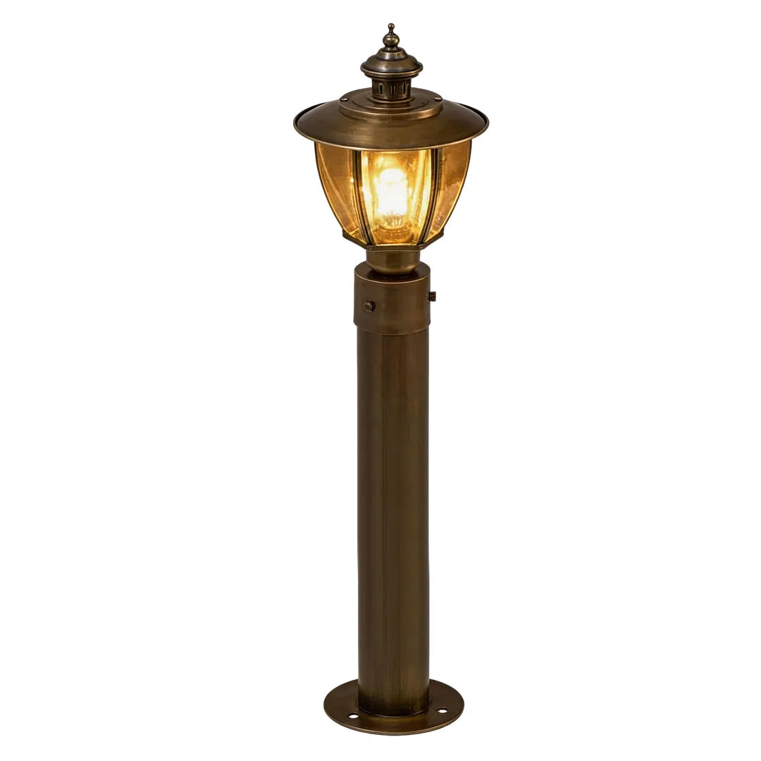 Tall vintage outdoor bollard light with bronze finish and warm lantern glow