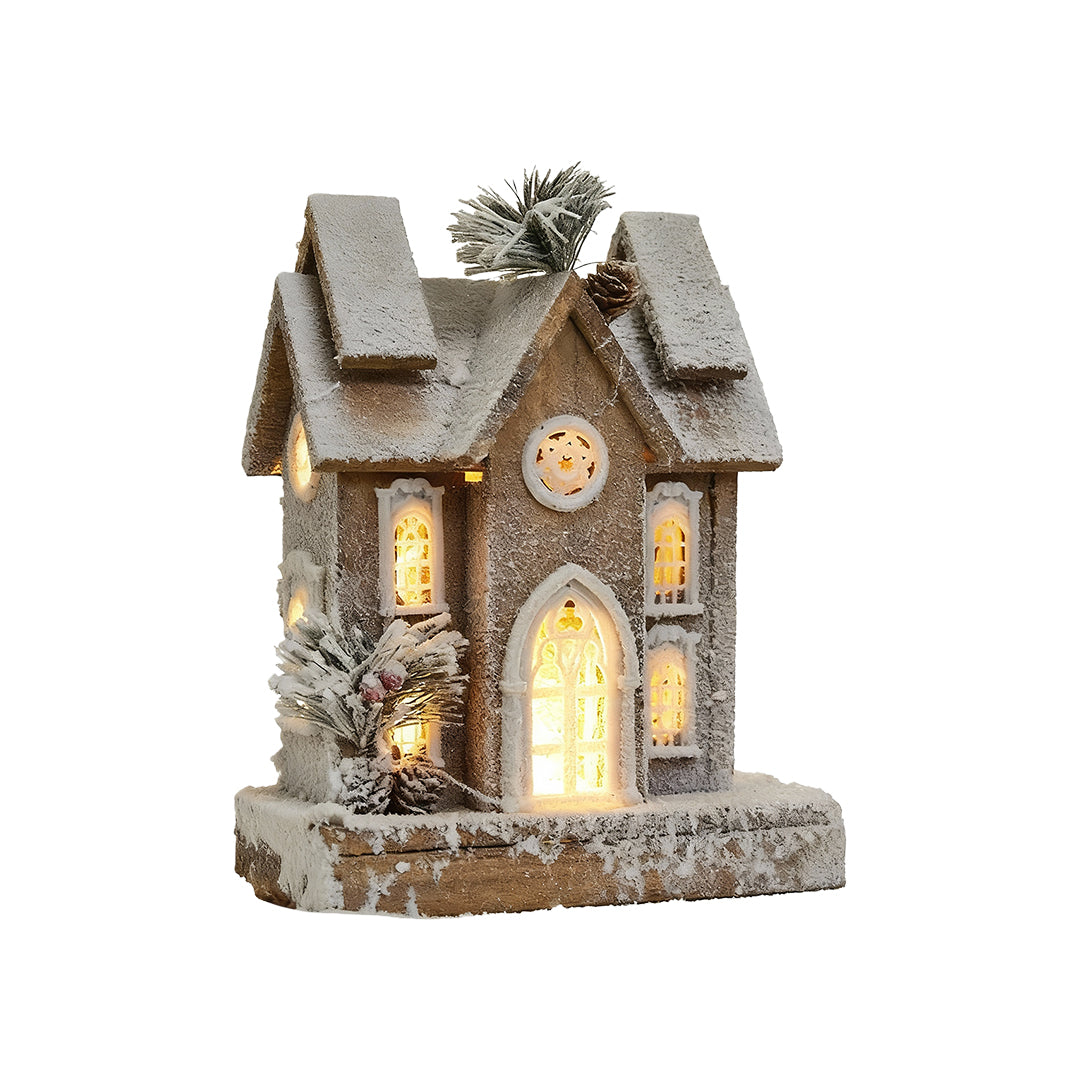 Tall wooden Christmas cottage with frosted roof, pine decor, and warm LED lighting.
