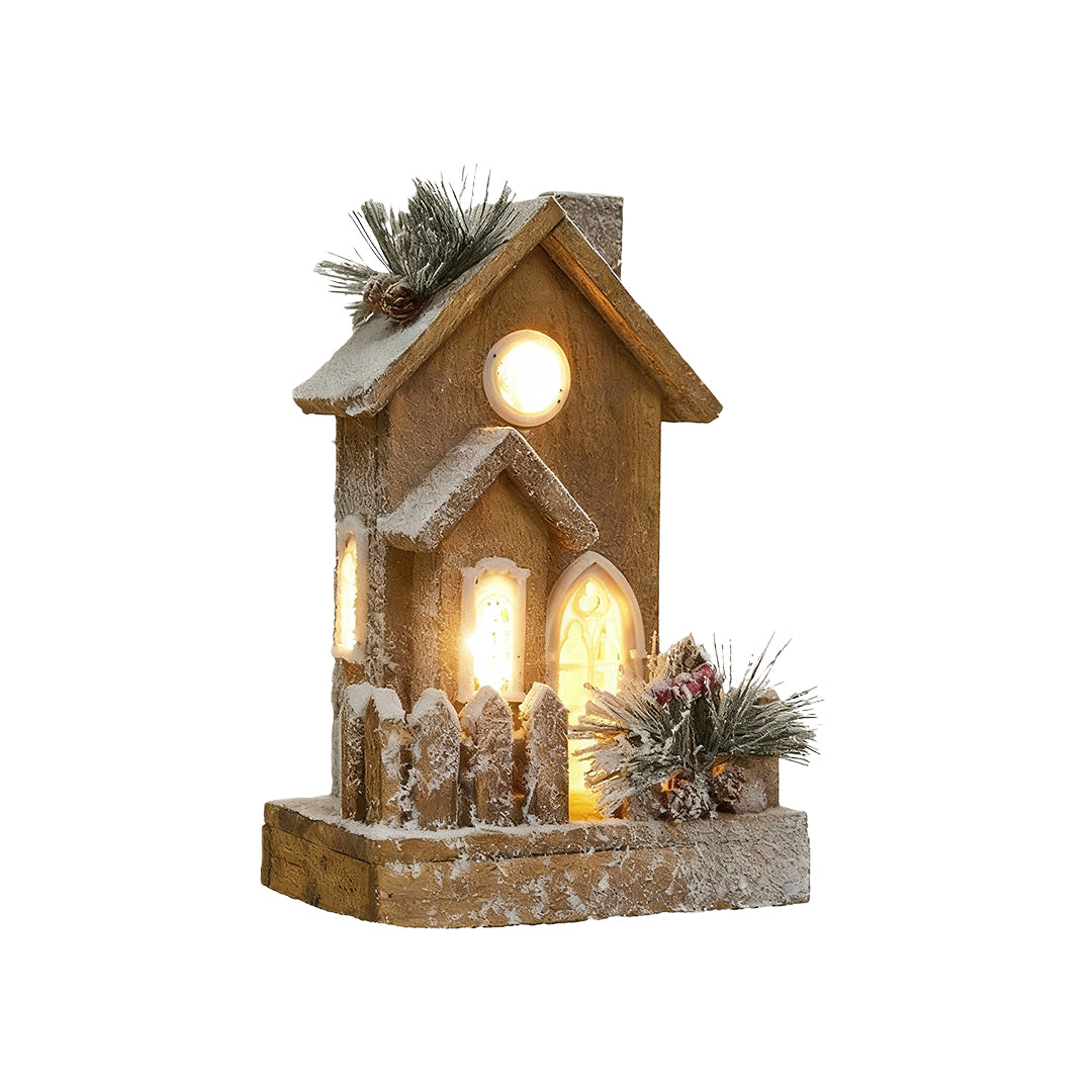 Tall wooden Christmas cottage with frosted roof, pine decor, and warm LED lighting.