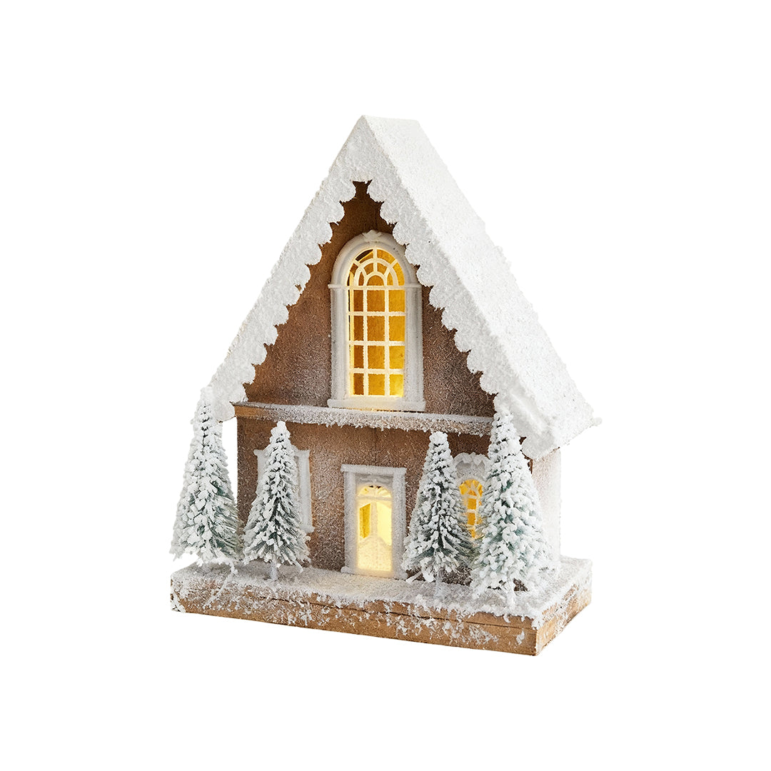 Tall wooden Christmas cottage with frosted roof, pine decor, and warm LED lighting.