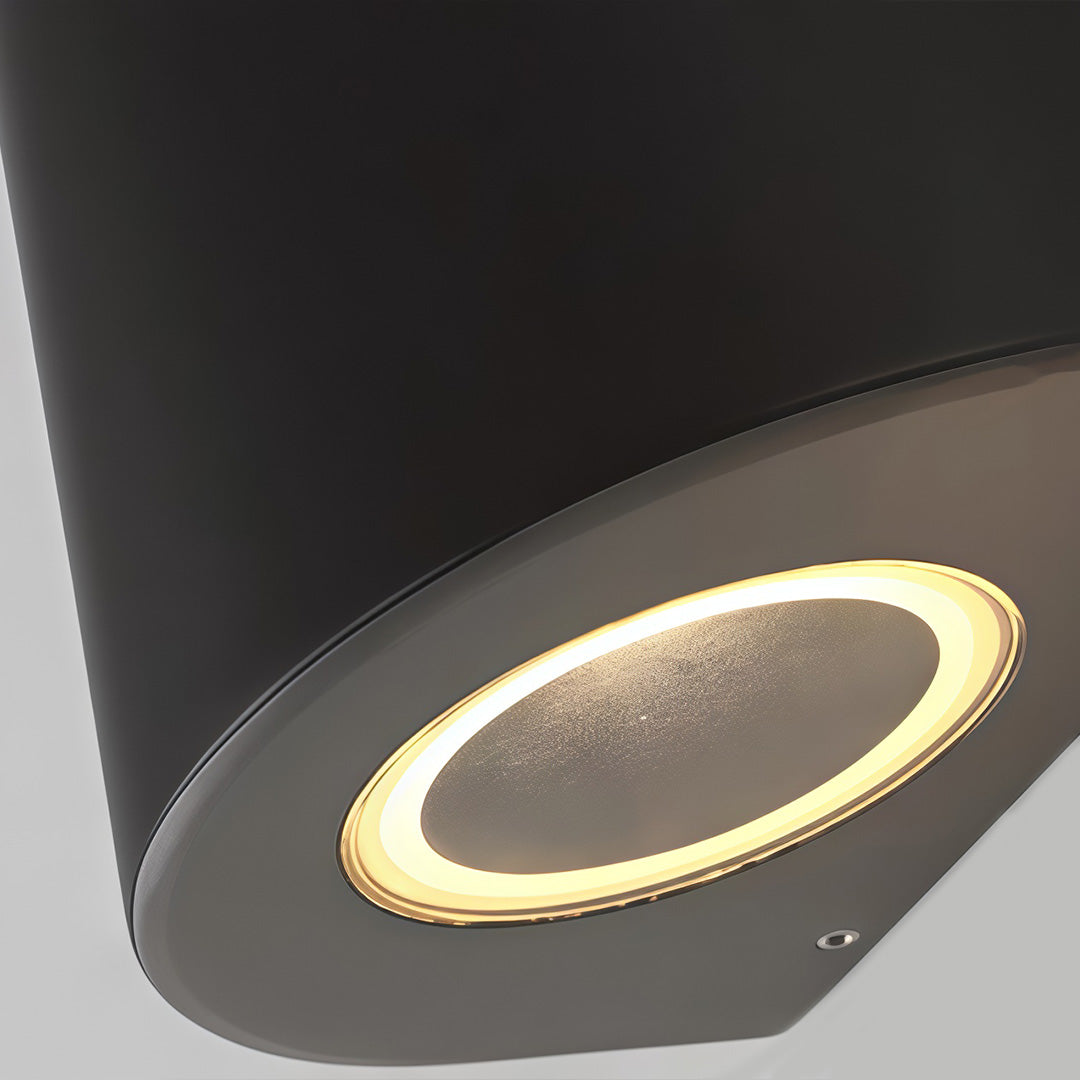 Tapered wall light with a close-up of the light source and housing.