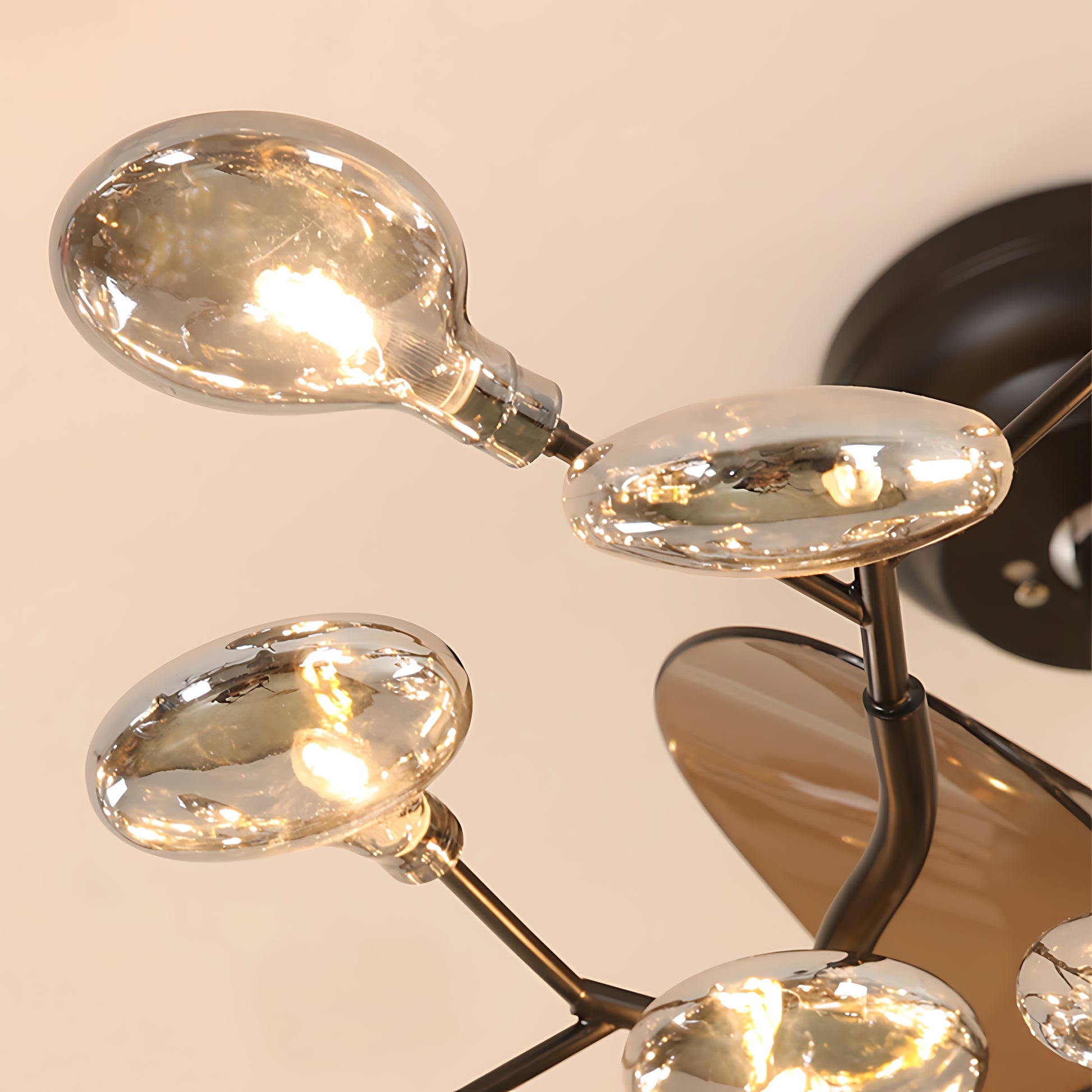 Close-up detail of glam ceiling fan light showing golden crystal leaf decorations and premium quality