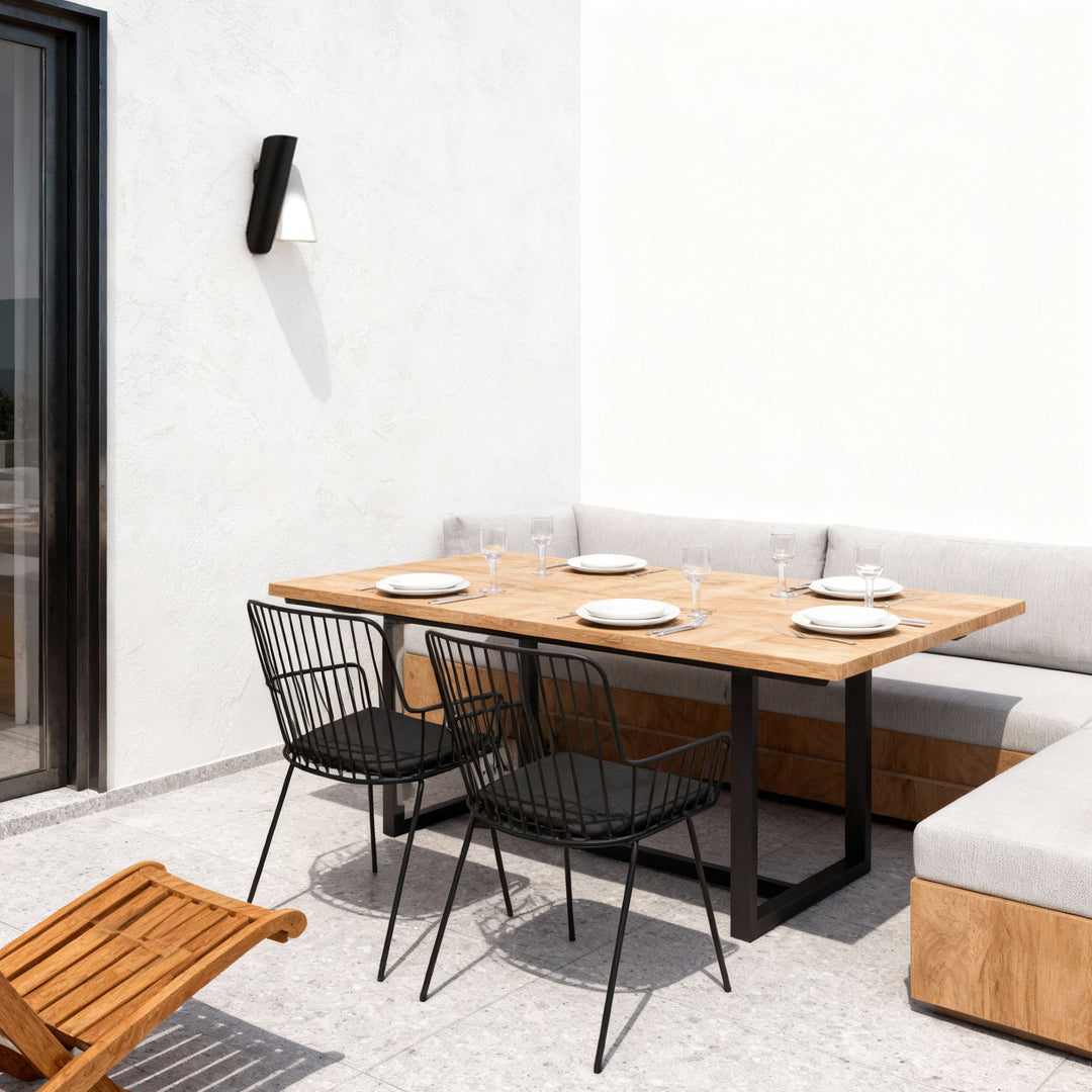 Up and down wall lights outdoor illuminating a terrace dining area with soft balanced lighting.