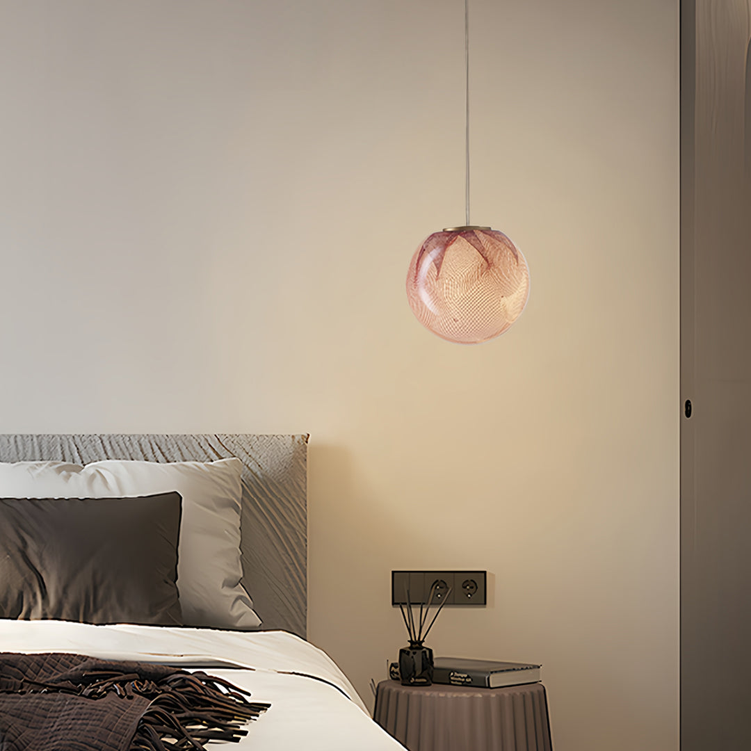 Artistic glass globe pendant lights showcasing textured amber glass surface with integrated LED technology for bedroom applications