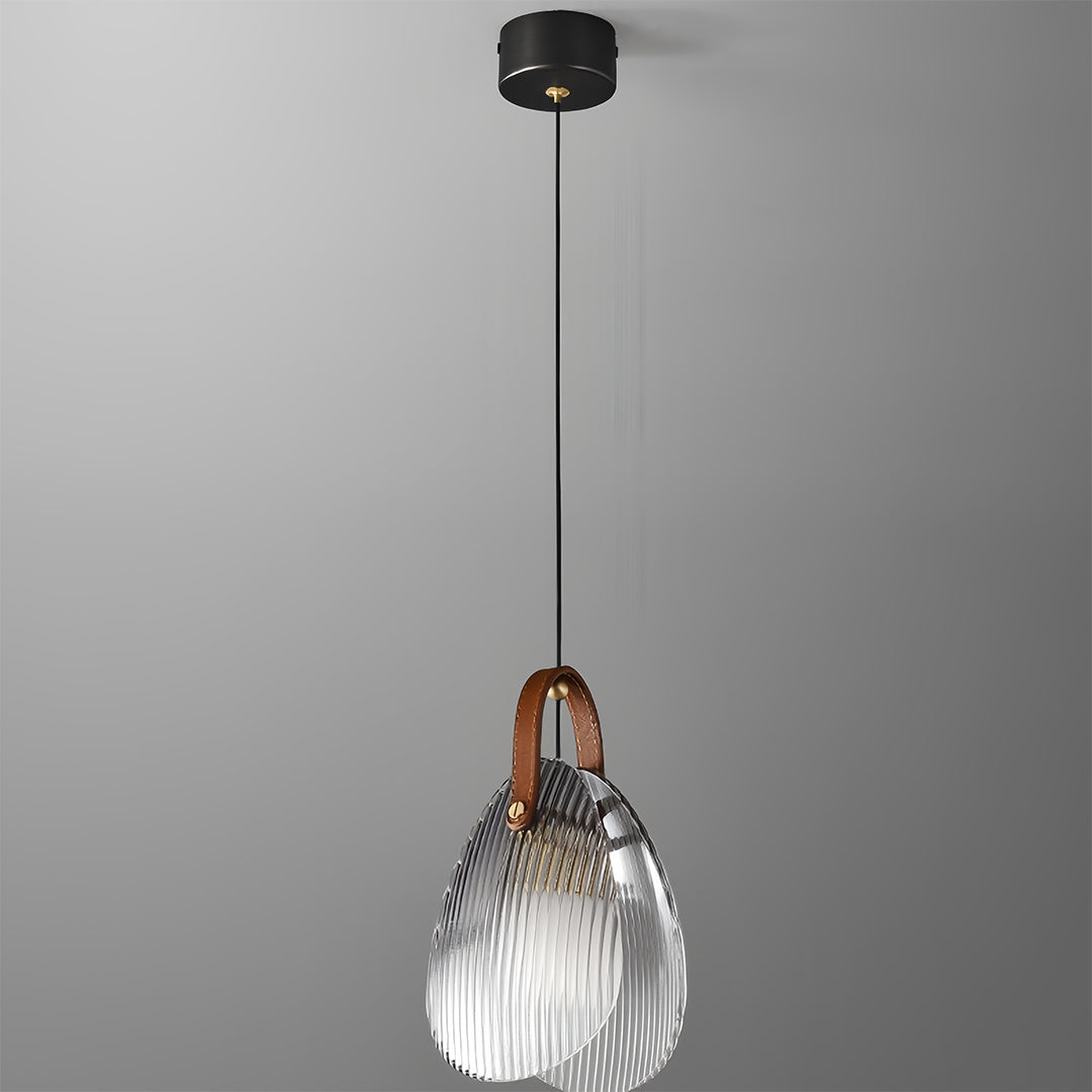 Single hanging glass pendant light with textured clear shade suspended from black ceiling fixture