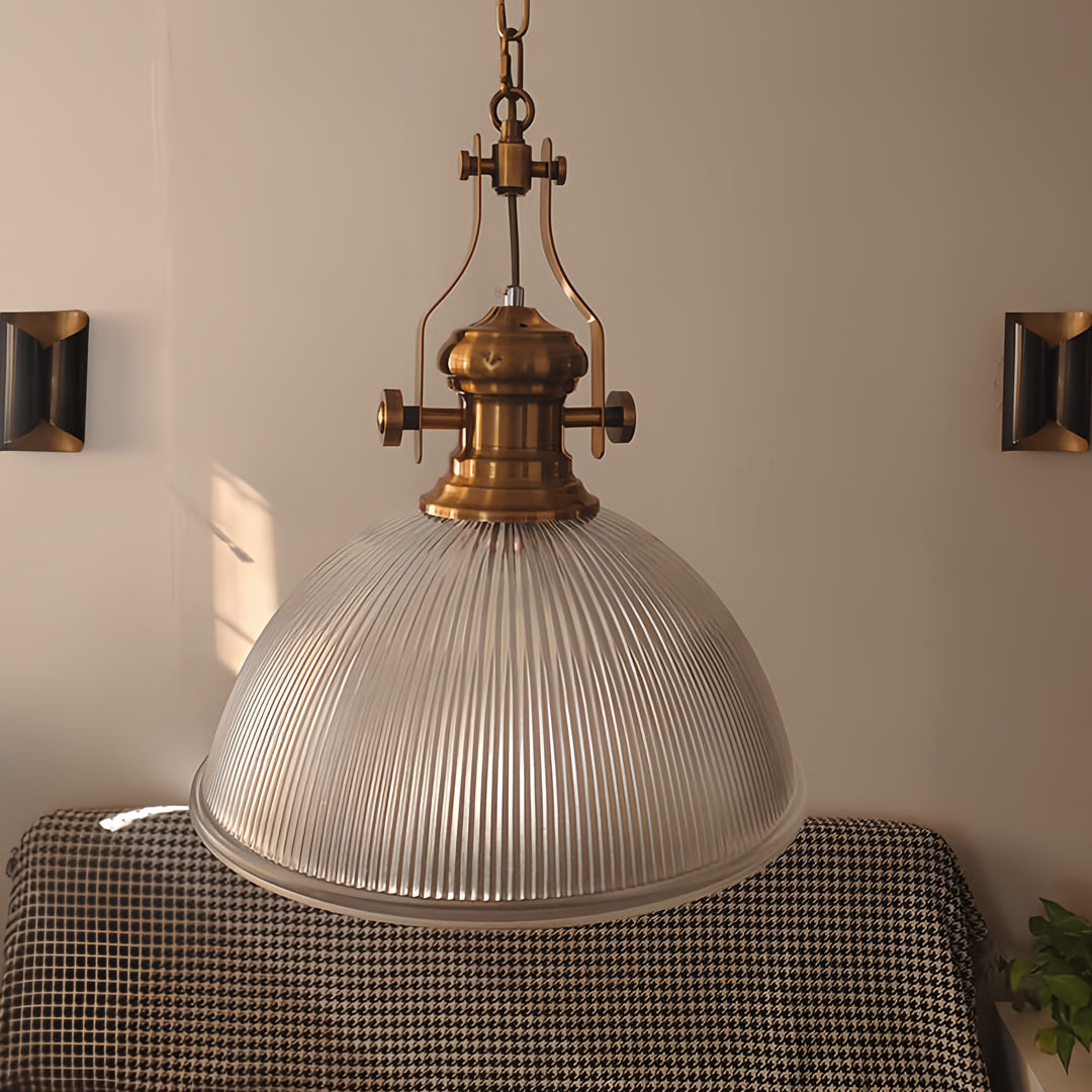 Textured glass pendant light in elegant dining room with warm lighting creating cozy atmospheric ambiance