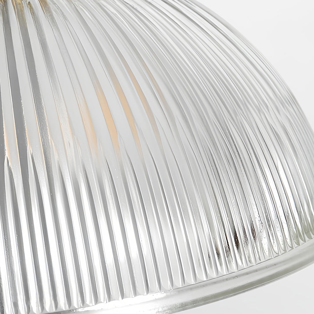 Textured glass pendant light illuminating wine cellar with warm brass finish and industrial-chic interior styling