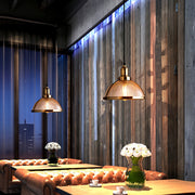 Textured glass pendant lights in modern kitchen with brass accents creating focused task lighting over workspace