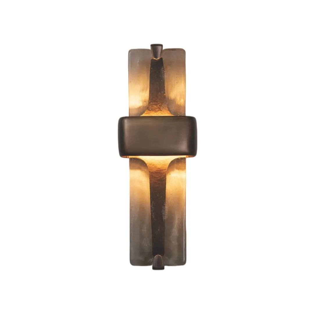 Textured glass wall sconce product image glowing warmly with amber illumination.