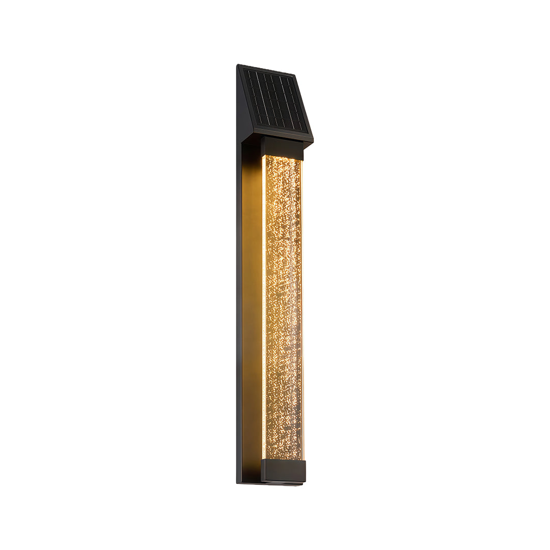 Black outdoor lighting sconce with a textured glass panel, providing warm and inviting illumination.