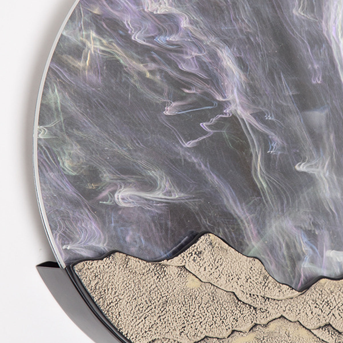 Textured circular wall fixture with natural stone appearance and geometric mountain design