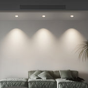 Three flush mount spotlights creating even wall washing in modern grey bedroom with textured artwork