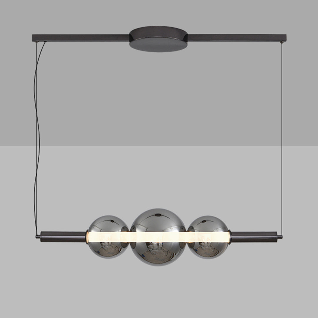 Modern silver pendant light for kitchen island with three clear globe shades suspended on black linear track