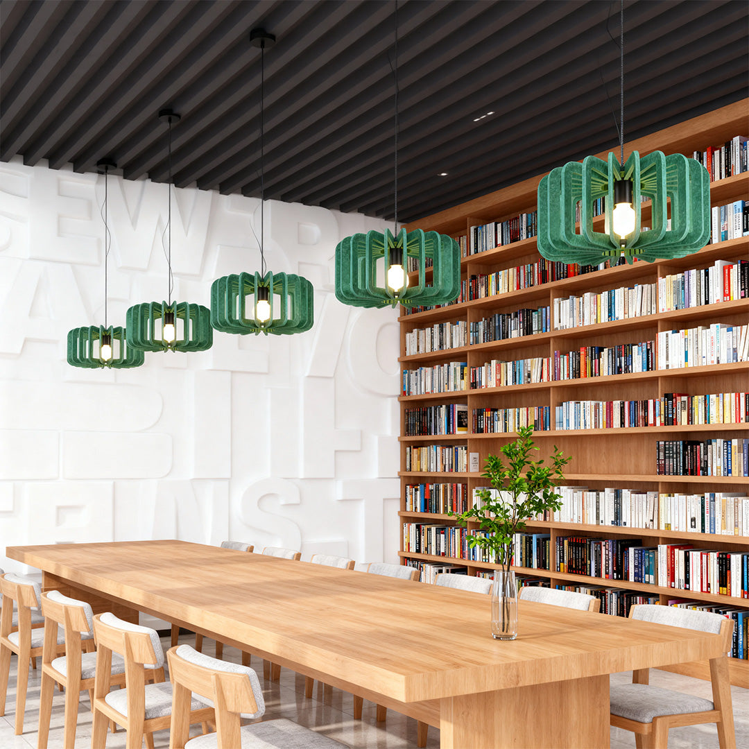 Row of three green felt material Nordic pendant lights illuminating a long library desk 